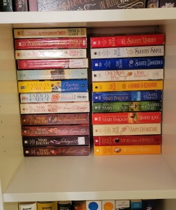 Square cubby of romance novels organized in two stacks. About 75 percent are Mary Balogh books, while the remaining books are by Patricia Cabot